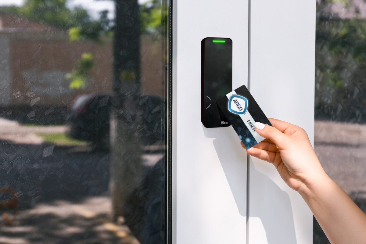 Woman using card to open door outdoors